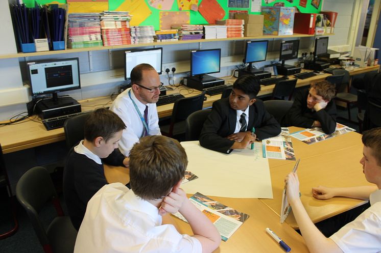Teacher Mr Smith with S3 pupils at Springburn Academy with the Money Wise textbooks