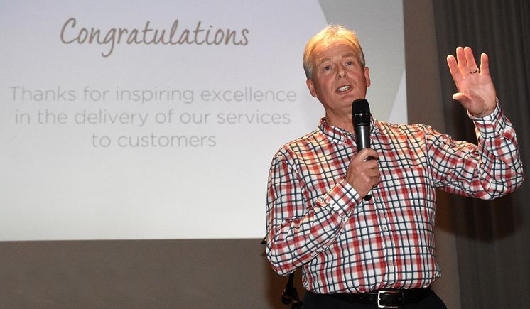 Managing director Kevin Carr congratulates go North East team members for inspiring excellence
