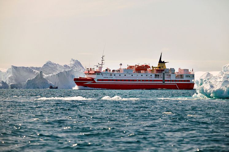 Fishing trawler and coastal ferry Sarfaq Ittuk among icebergs in Ilulissat Icefjord in Greenland
